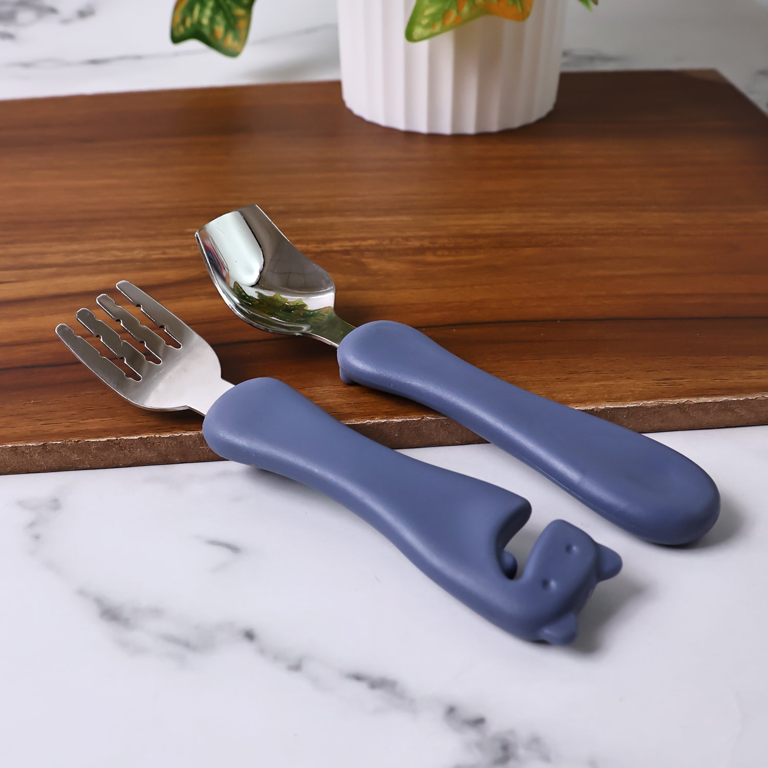 Wukusy Supermom Foodie stainless steel spoon and fork set, sleek and durable for home and kitchen use, shown on a white background.