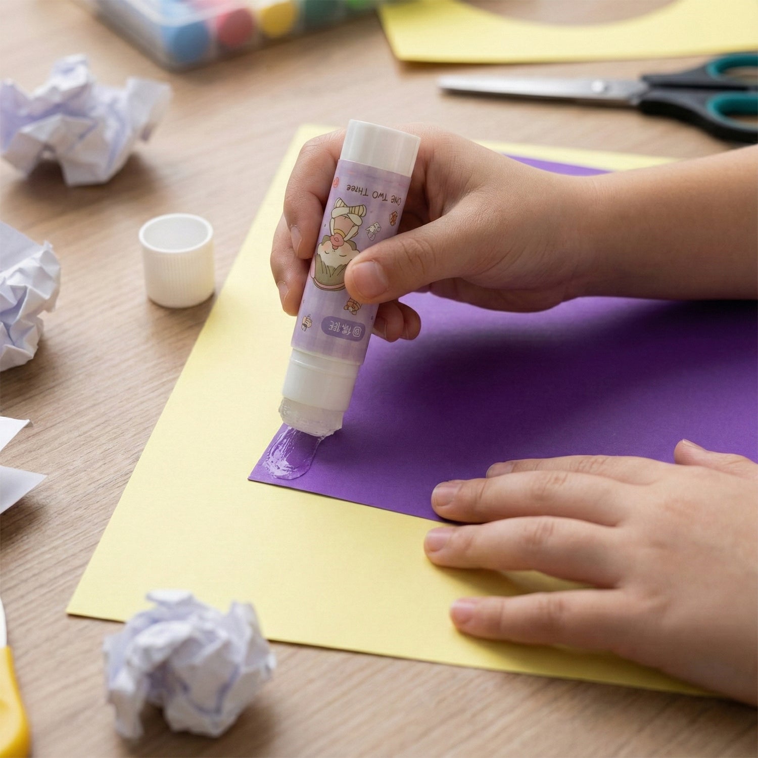 Pack of 5 Wukusy cartoon-themed solid glue sticks for arts and crafts, featuring colorful, playful packaging and cartoon designs.