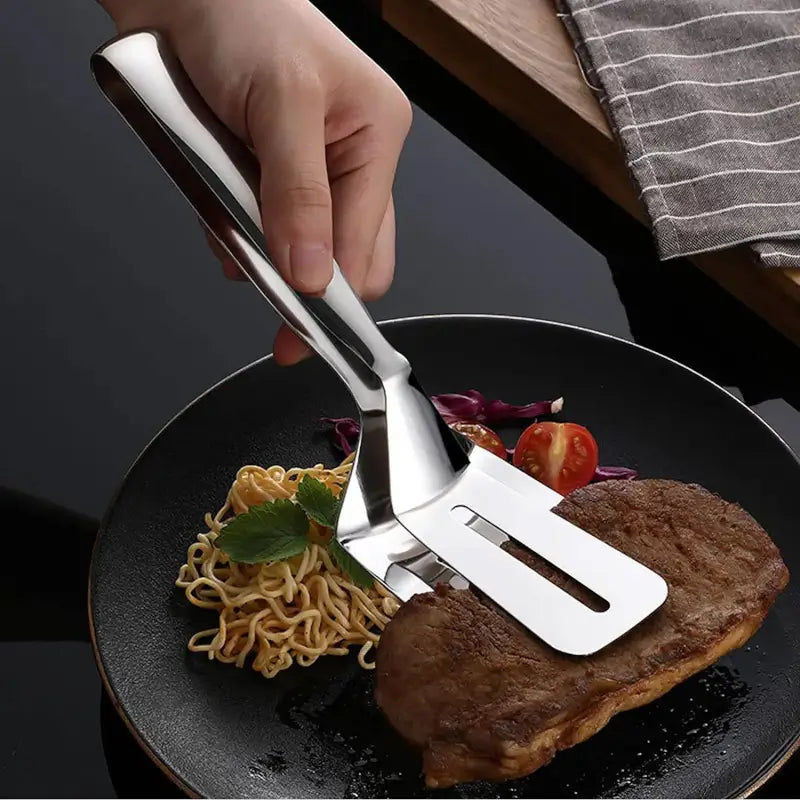 Ekom stainless steel multifunction cooking turner and food tong with steak clip clamp, ideal for BBQ and kitchen serving tasks.