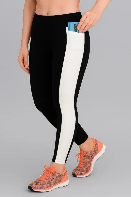 Black Ekom women's mid-waist gym leggings with soft fabric and stylish design, ideal for yoga and fitness activities.