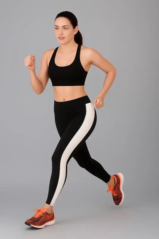 Black Ekom women's mid-waist gym leggings with soft fabric and stylish design, perfect for yoga and fitness activities.