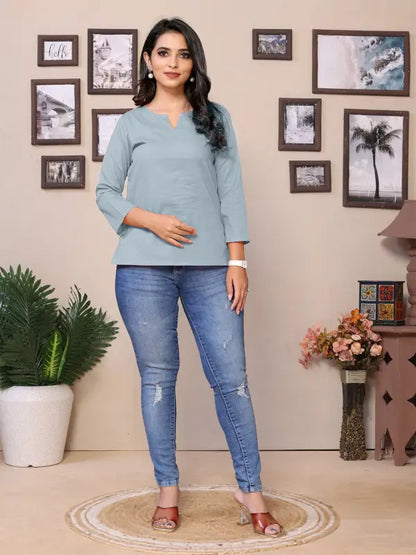Baby pink cotton women's V-neck tunic with 3/4 sleeves, hip length, round neckline, by Ekom, shown on a woman.