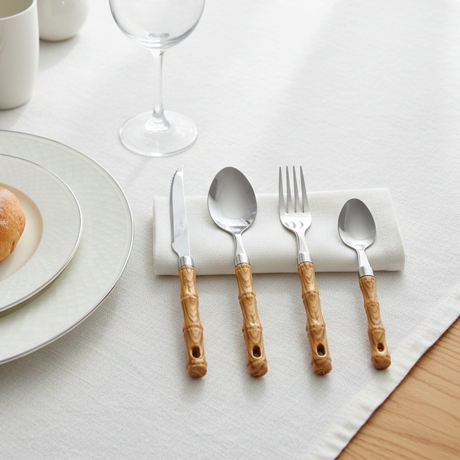 24-piece stainless steel cutlery set with wooden finish handles by Wukusy, including forks, knives, spoons, and teaspoons.