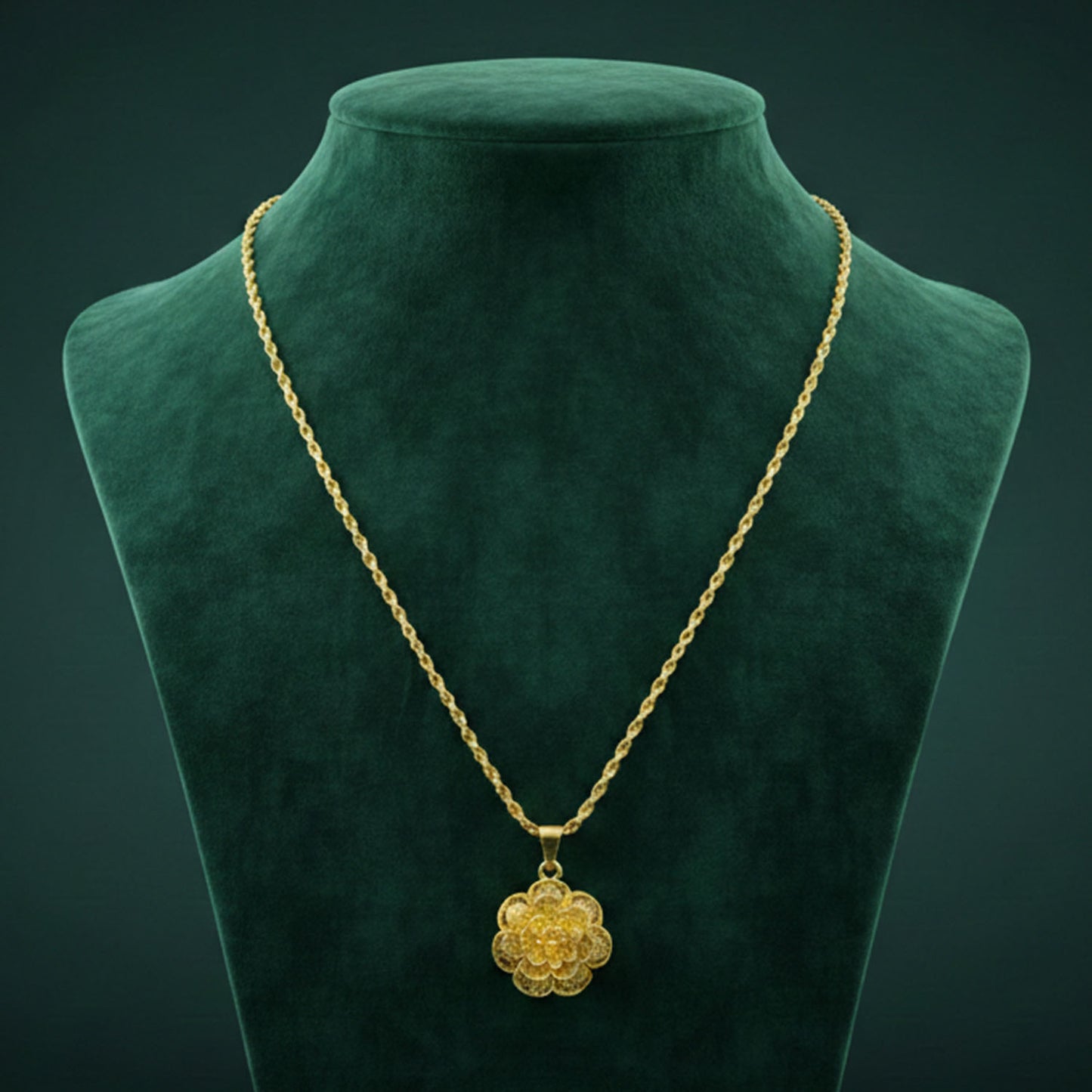 Gold plated pendant necklace with elegant floral design by Wukusy, featuring intricate detailing and a delicate chain.