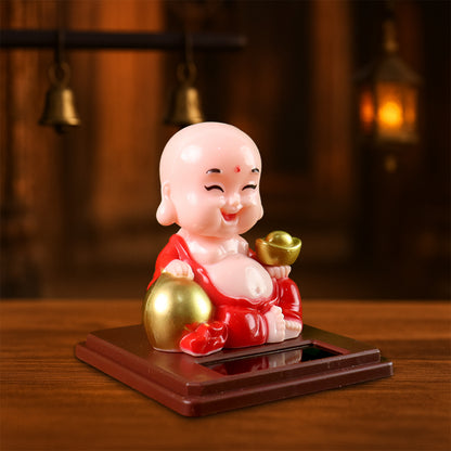 Wukusy solar-powered moving head Buddha statue car ornament in mixed colors, designed to attach to vehicle dashboards or dashboards.
