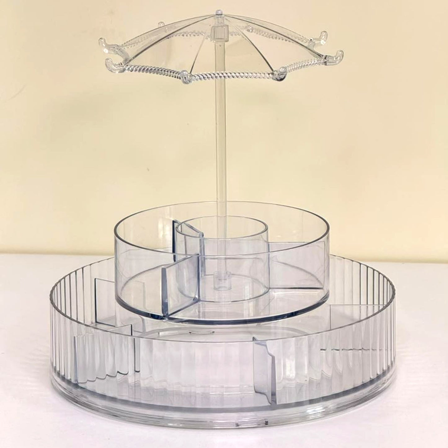 Wukusy premium 360 rotating makeup and jewelry organizer stand with multiple compartments for cosmetics and accessories.