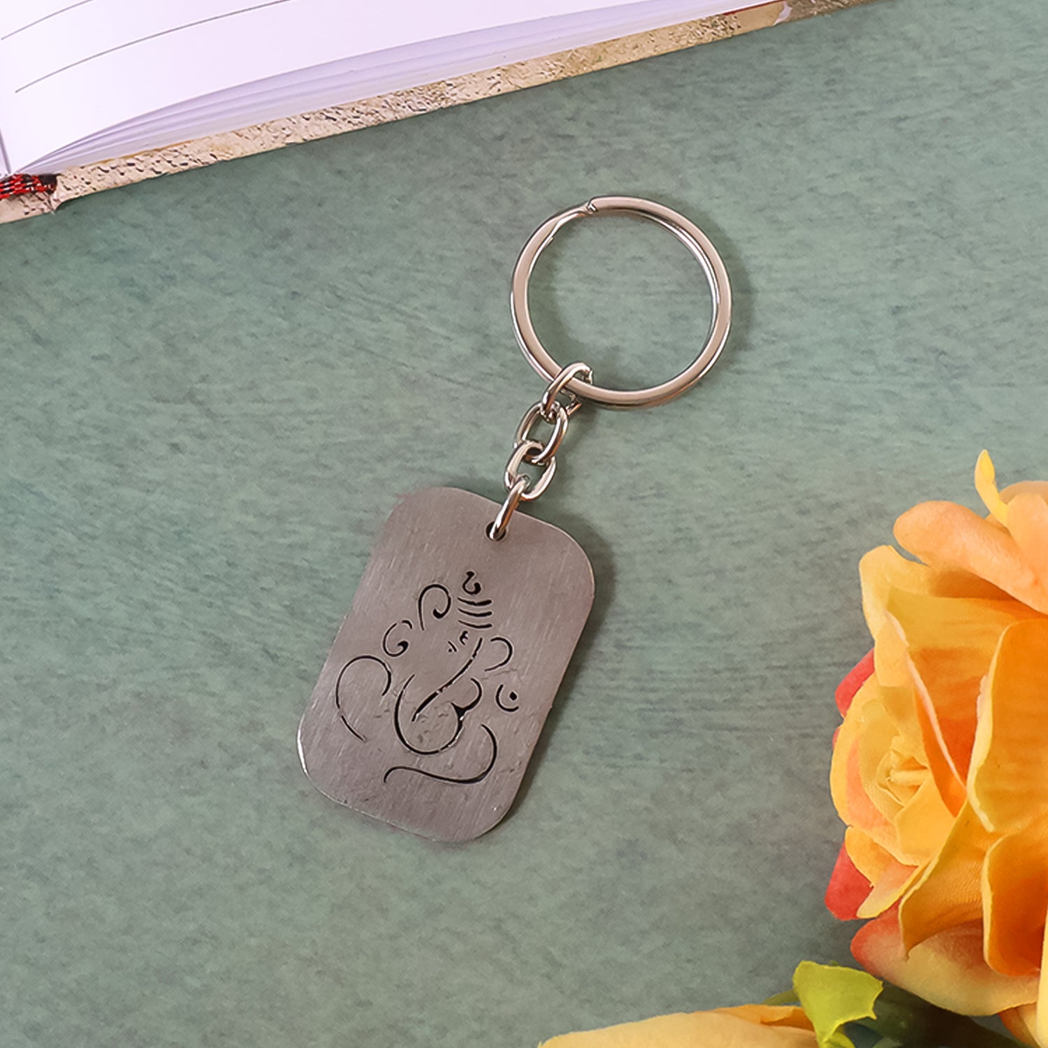 Wukusy Ganesh metal keychain with auspicious cut-out design, featuring intricate Hindu deity silhouette for home or personal use