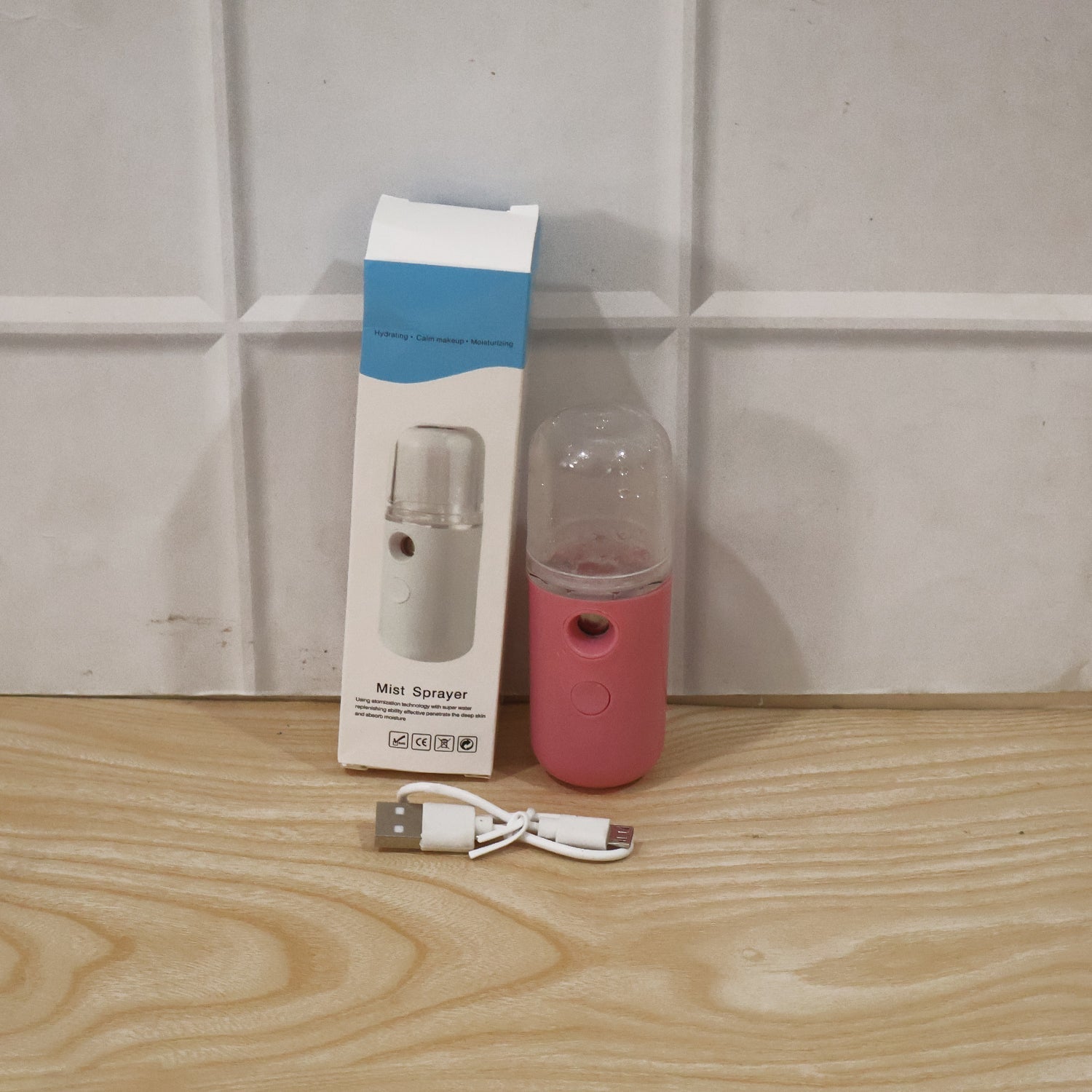 Portable Wukusy mini nano mist sprayer face steamer with USB rechargeable humidifier, compact and handheld for skincare use.