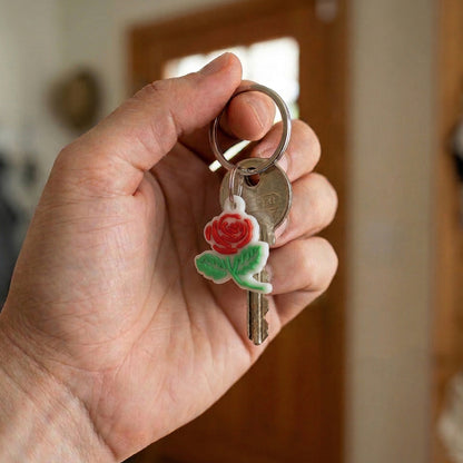 Set of 10 Wukusy rose flower design bag charm keychains with colorful, decorative floral accessories on each keychain.