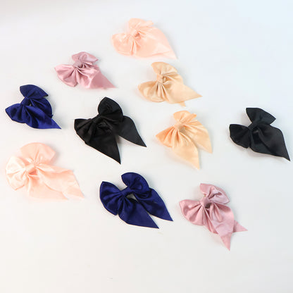 Set of 10 Wukusy satin bow hair clips for girls and women, featuring colorful, elegant hair accessories for various hairstyles.