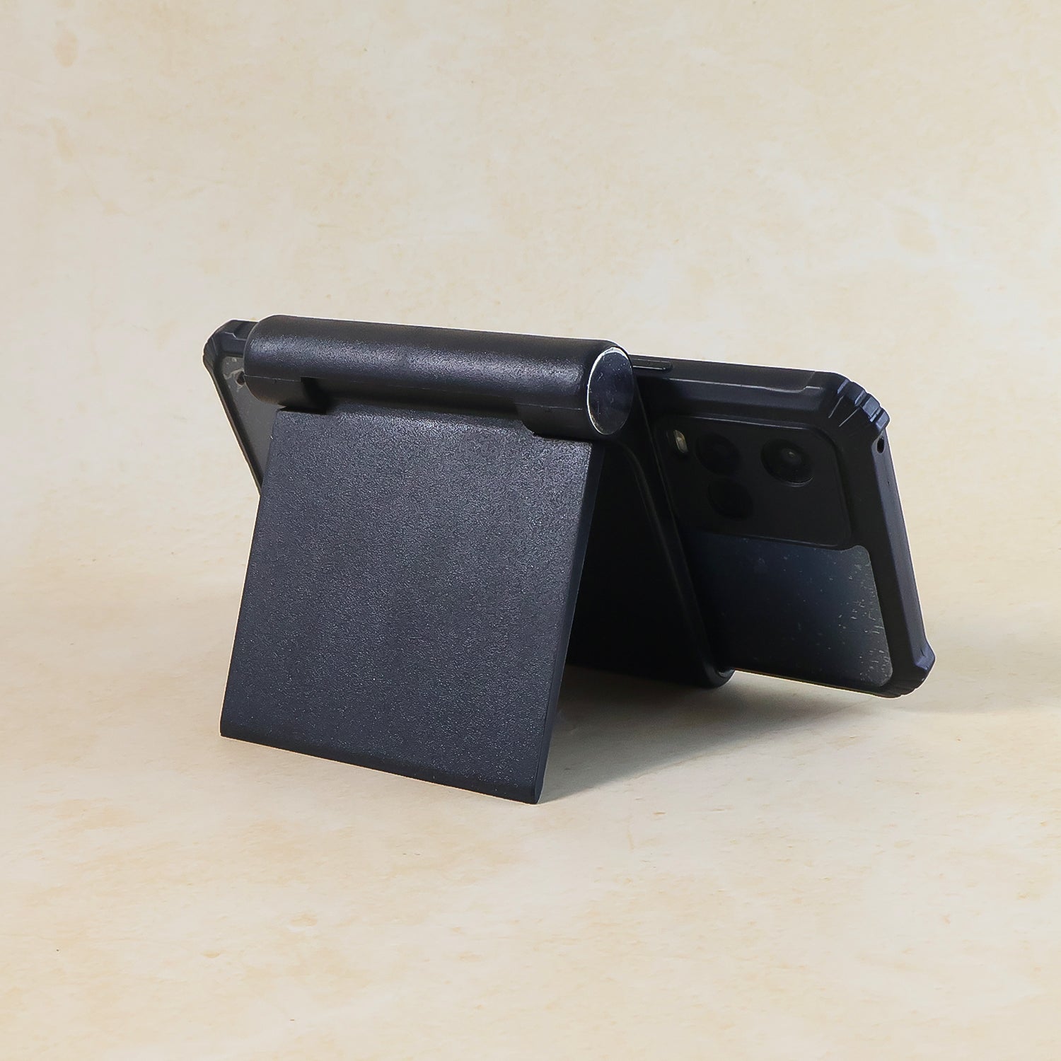 Black plastic foldable desktop mobile stand by Wukusy, adjustable holder for smartphones with compact design.