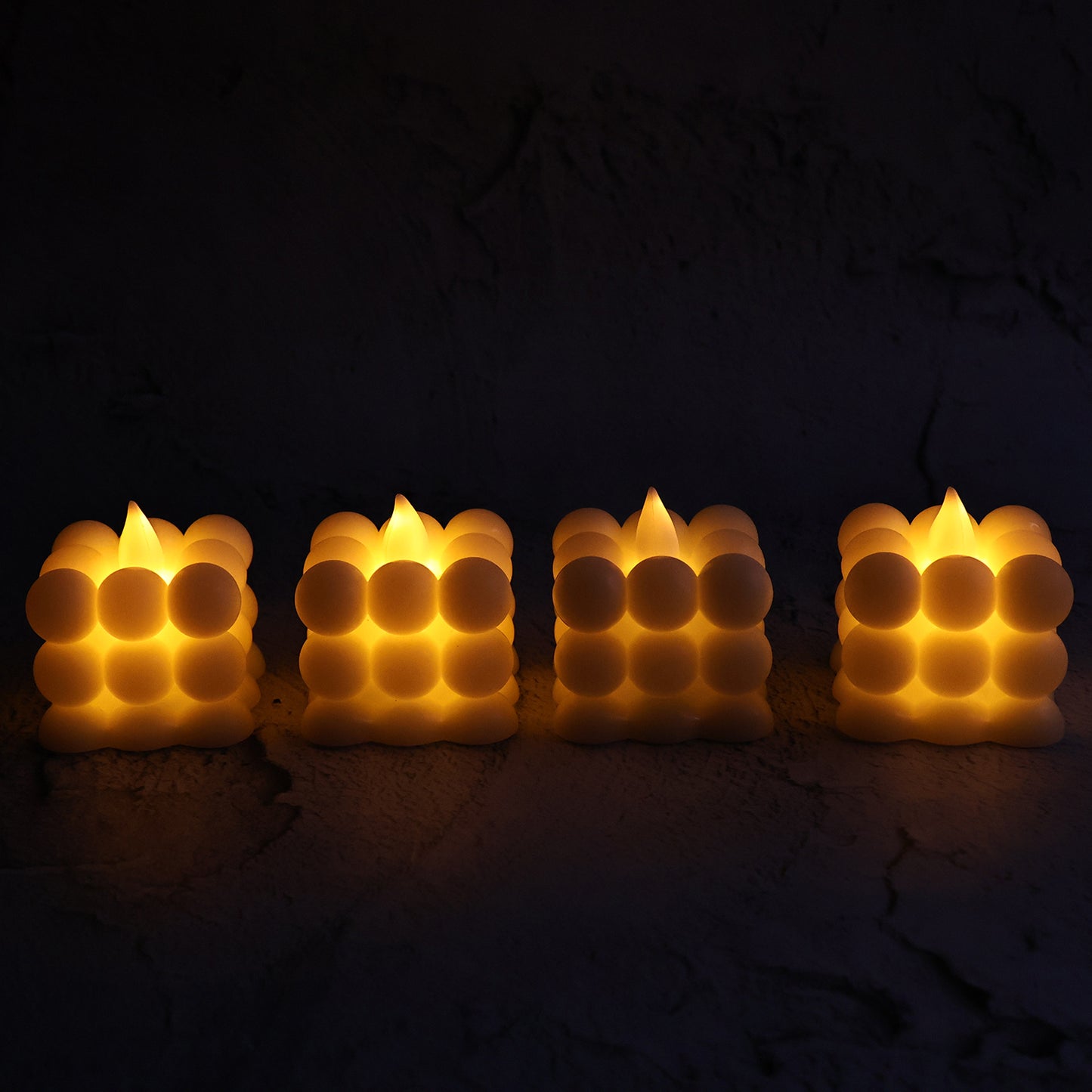 Set of four Wukusy decorative LED bubble candles for home decor, featuring glowing, textured bubble designs in a stylish display.