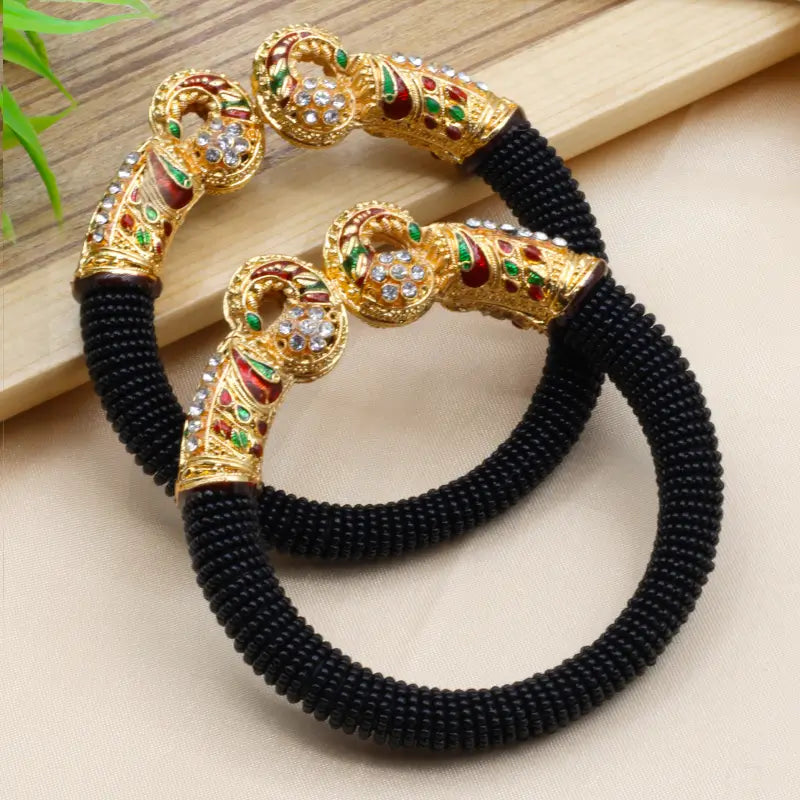 Traditional peacock design pearl bangles for women featuring intricate craftsmanship and elegant white pearls, by Ekom.