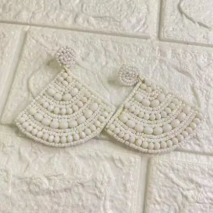 Handmade cone-shaped beaded earrings by Ekom featuring colorful, intricate beaded jewelry in a stylish fashion design.