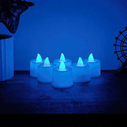 Six blue LED tea light candles from Wukusy, glowing with a soft, flickering light, perfect for ambiance and decorative use.