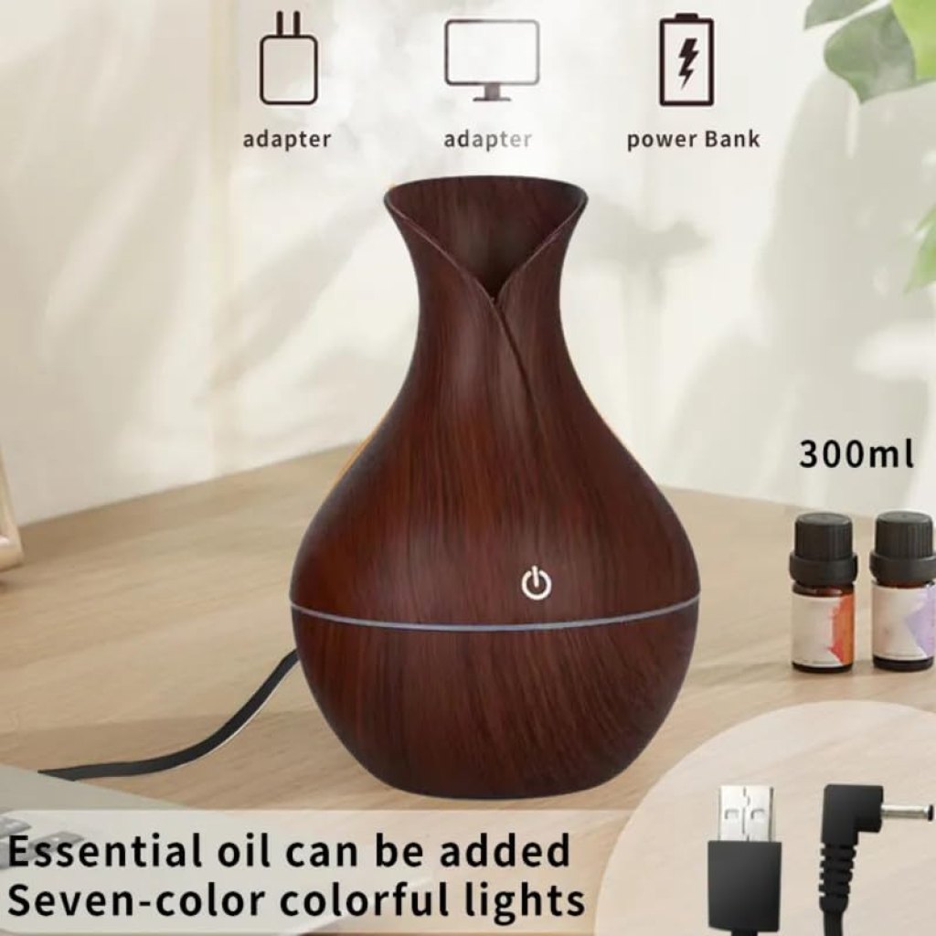 Pot-shaped wooden humidifier by FIZZI SHOP JK SIDHU with a natural wood finish and a small opening for mist release.