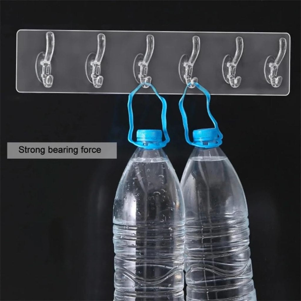 Six FIZZI SHOP self-adhesive hook stickers attached to a wall, showing their versatile use for hanging items.