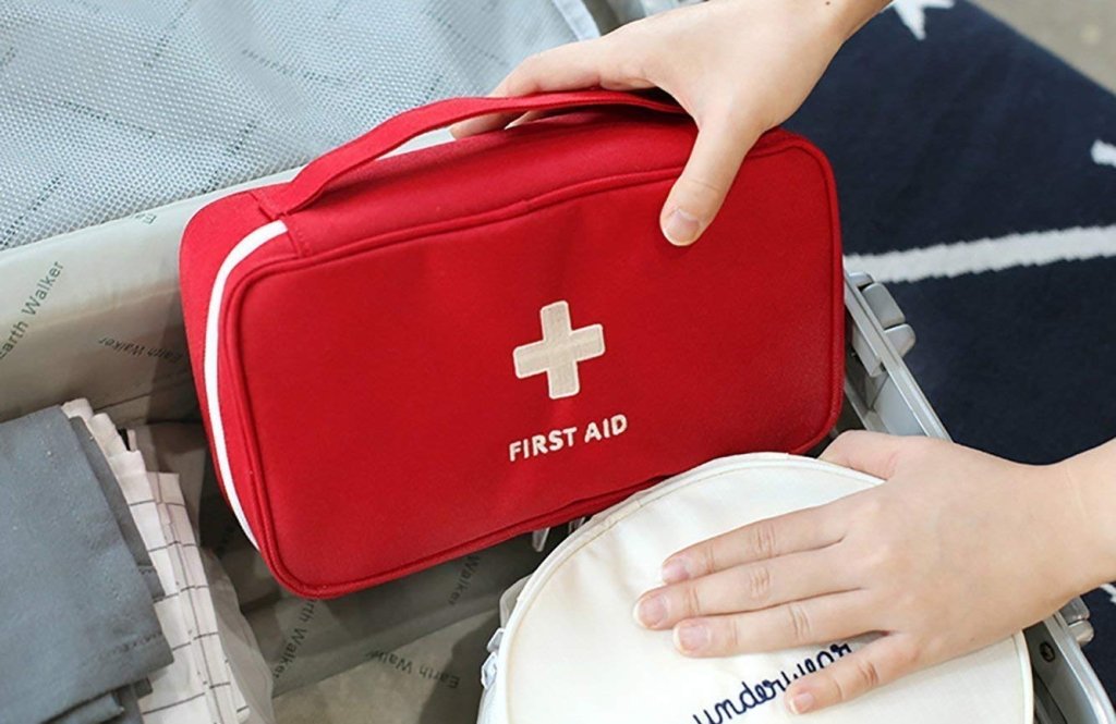 First Aid Travel Medicine Pouch by FIZZI SHOP JK SIDHU, compact medical kit with bandages and first aid supplies inside.