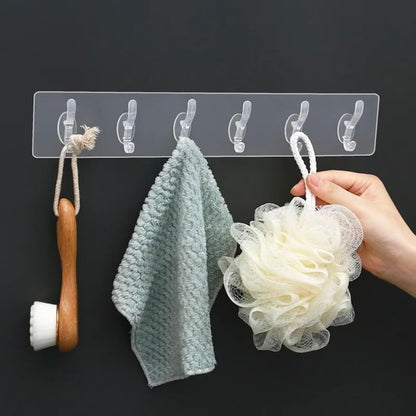 Six self-adhesive hook stickers from FIZZI SHOP, showing clear plastic hooks mounted on a wall for hanging lightweight items.