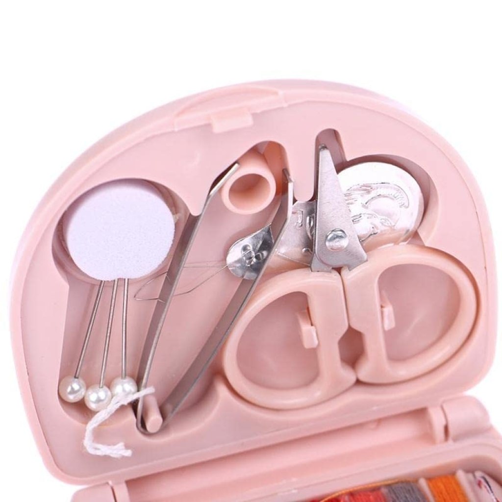 Mini travel sewing kit by FIZZI SHOP JK SIDHU with small scissors, needles, and thread in a compact case for on-the-go repairs.