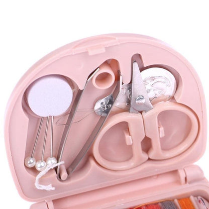 Mini travel sewing kit by FIZZI SHOP JK SIDHU with small scissors, needles, and thread in a compact case for on-the-go repairs.