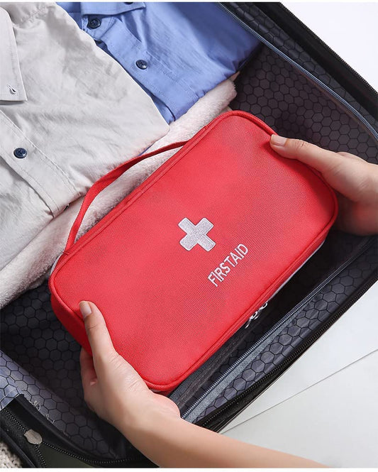First Aid Travel Medicine Pouch by FIZZI SHOP JK SIDHU showing compact medical kit with bandages and essential supplies inside.