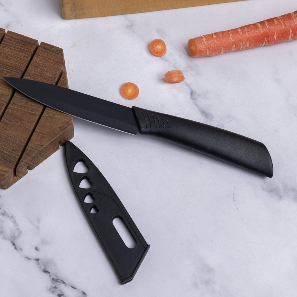 Three-piece FIZZI SHOP JK SIDHU knife set with stainless steel blades and ergonomic handles on a wooden surface.