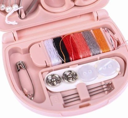 Mini travel sewing kit by FIZZI SHOP JK SIDHU with colorful threads, needles, and small sewing accessories in a compact case.