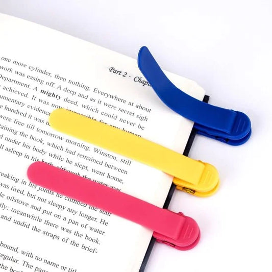 Three silicone automatic bookmarks in bright colors, designed for easy page marking and reading convenience.