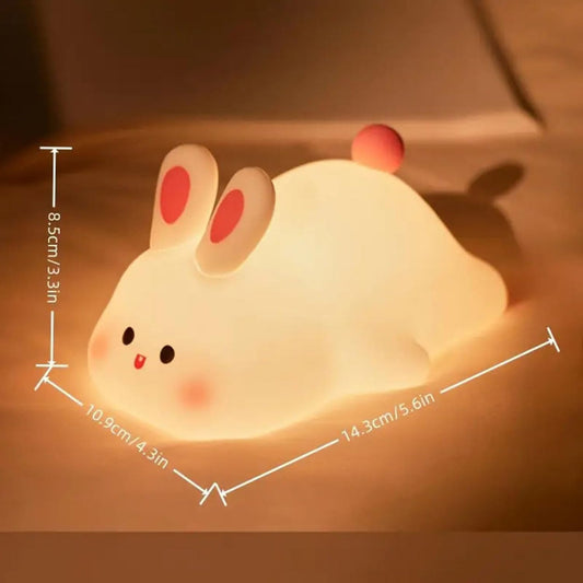 Silicone rabbit lamp by FIZZI SHOP, soft pink color, cute bunny shape, ideal for children's room decor and night lighting.