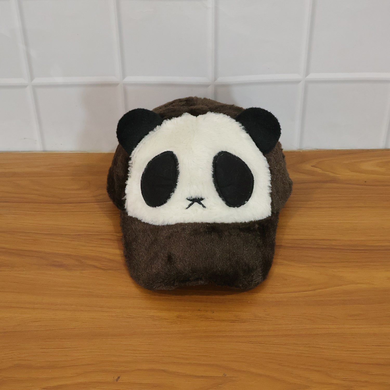 Wukusy cute panda design plush winter cap showing a soft, cozy black and white panda face with ear details.