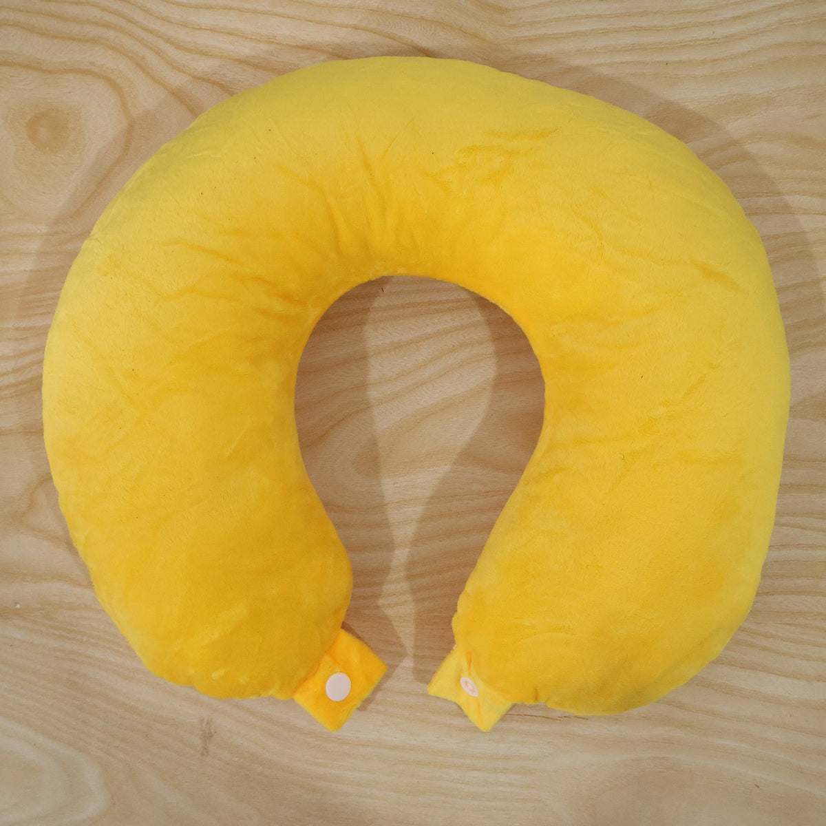 Wukusy soft U-shaped neck travel pillow supporting head and neck during flights with plush cushioning in light blue fabric.