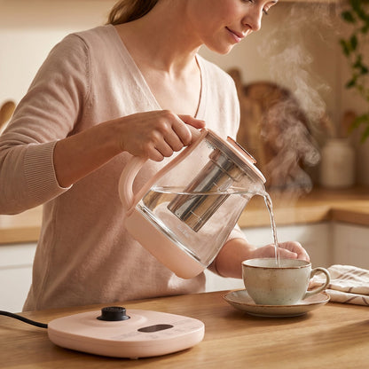 Wukusy Suta electric glass kettle with 2.3L capacity, tea infuser, and temperature control on a kitchen countertop.