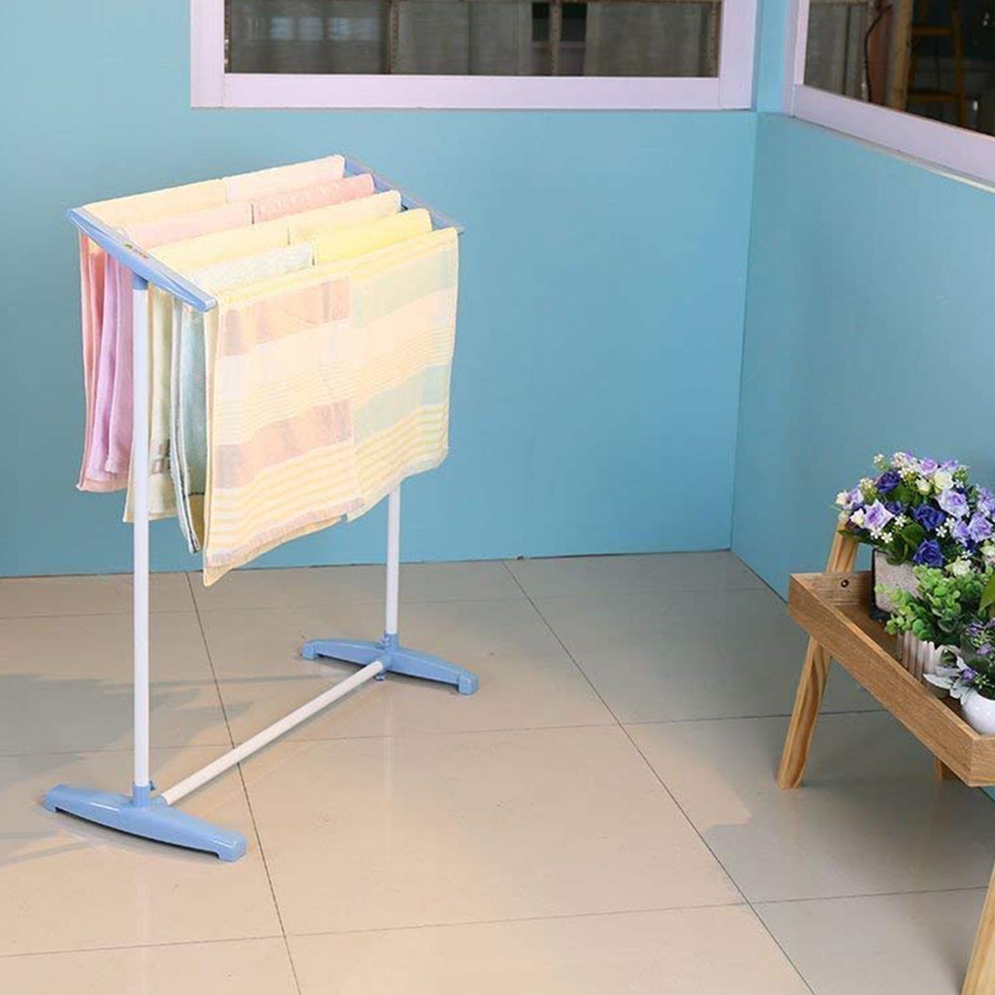 Wukusy stainless steel and plastic multi-functional single tier mobile towel and cloth rack for indoor or outdoor use.