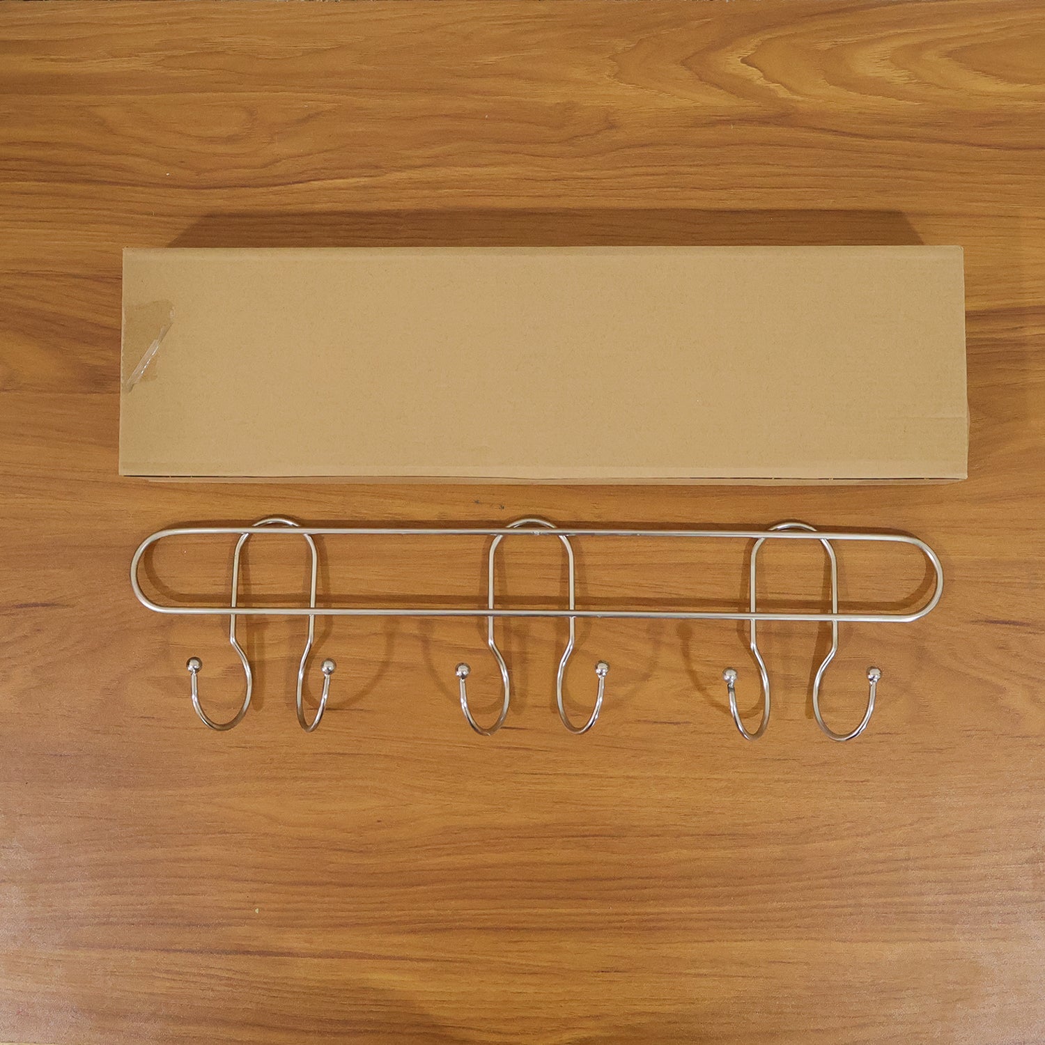 Wall-mounted metal multi-hook rack by Wukusy, featuring several sturdy hooks for organizing keys, coats, or accessories.