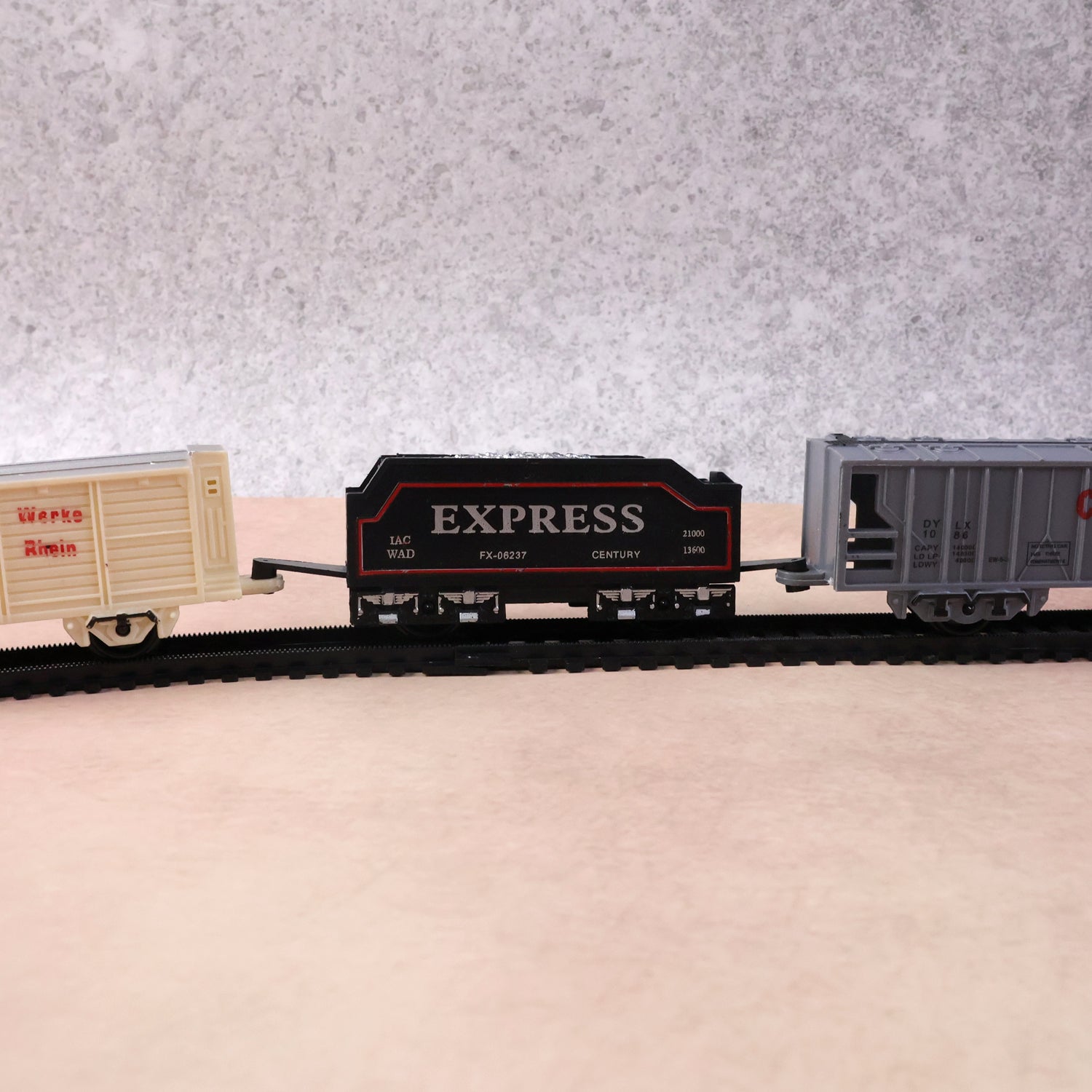 Battery-operated toy train set by Wukusy with colorful track and train cars for kids, perfect for imaginative play.