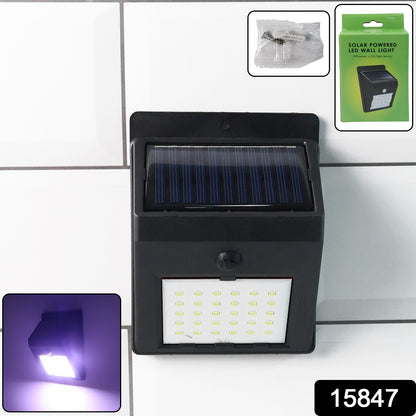 Wukusy solar-powered LED wall light mounted on a garden wall, providing eco-friendly outdoor lighting during nighttime.