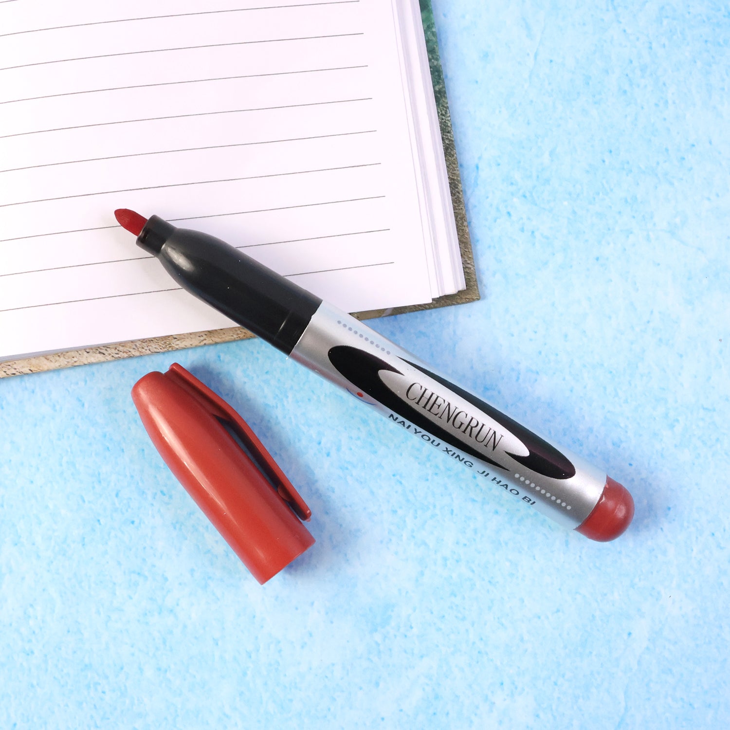 Maroon Wukusy premium permanent marker pen with fine tip, displayed on a white background, showing the pen's color and design.