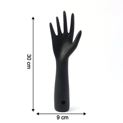 Black hand-shaped jewelry display stand by Wukusy showing multiple rings and necklaces on a white background