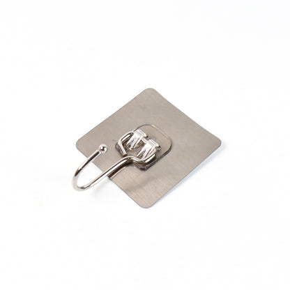 Large stainless steel Wukusy self-adhesive wall hook for home and kitchen, shown attached to a wall holding lightweight items.