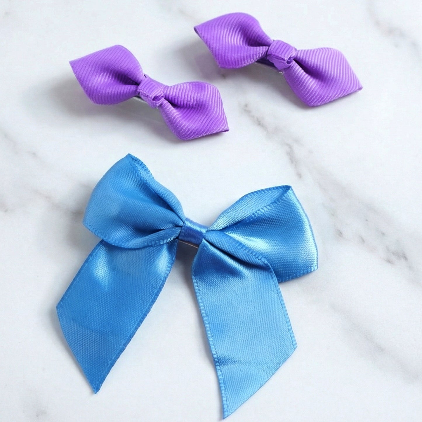 Set of three Wukusy satin ribbon bow hair clips with elegant, colorful bows for stylish hair accessories.