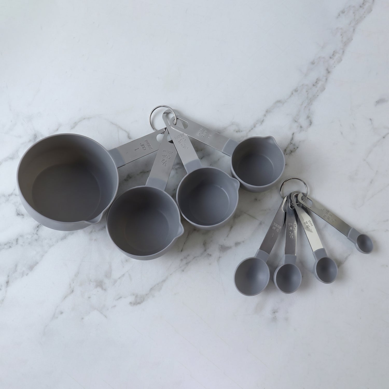 Set of Wukusy plastic measuring cups and spoons for kitchen baking and cooking, displayed together on a neutral background.
