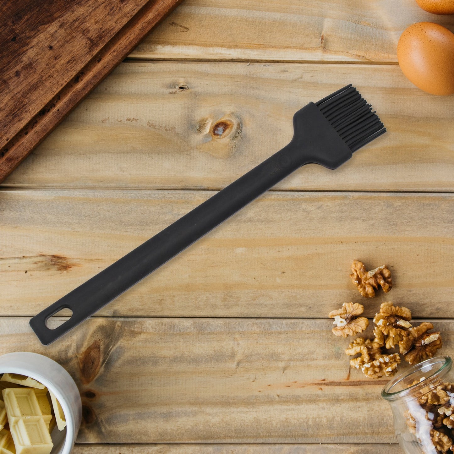 Wukusy 5413 silicone basting brush with a wooden handle, used for baking, BBQ, and pastry applications in the kitchen.