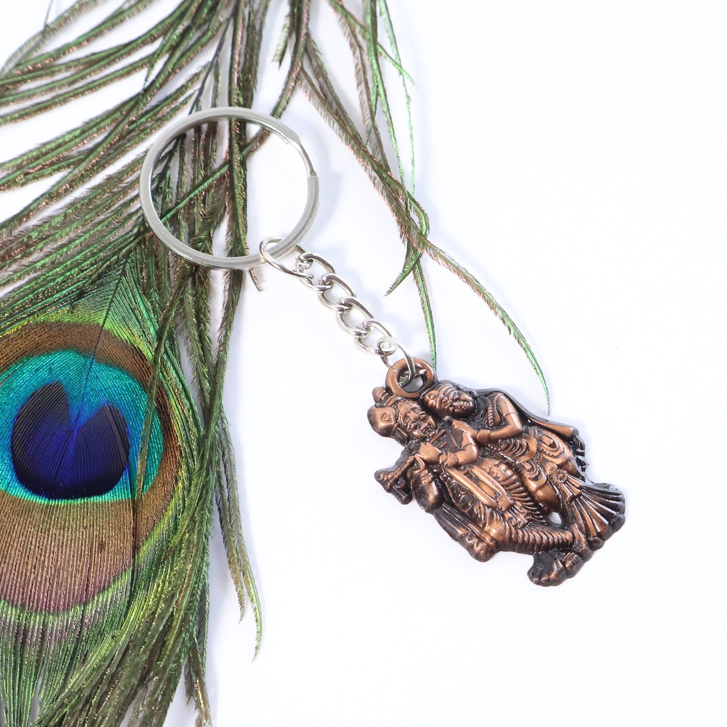 Pair of Radha Krishna metal keychains with intricate designs, featuring traditional Indian art in a 2-piece set by Wukusy.