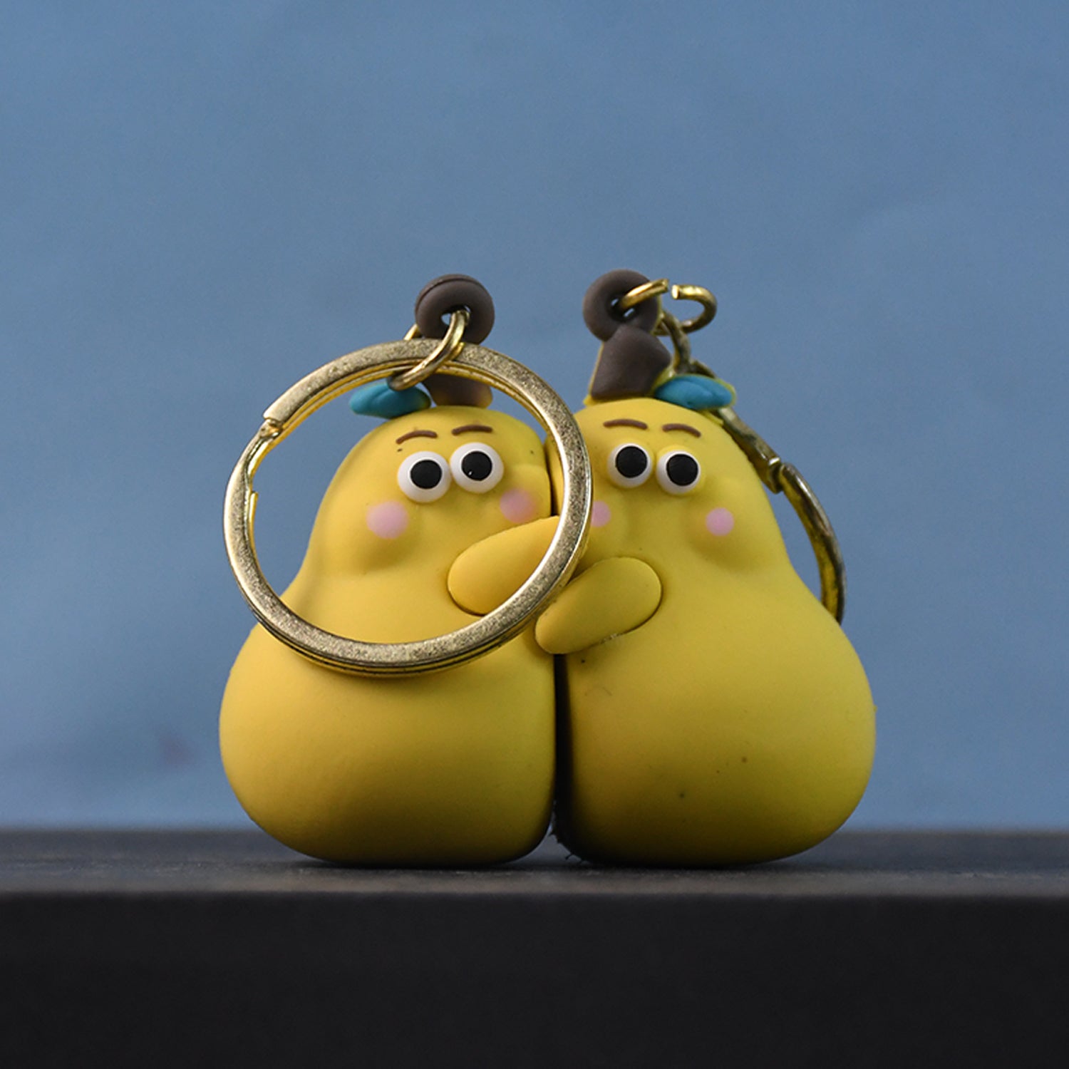 Cute cartoon couple keychain with colorful toy design from Wukusy, perfect for keys or bags.