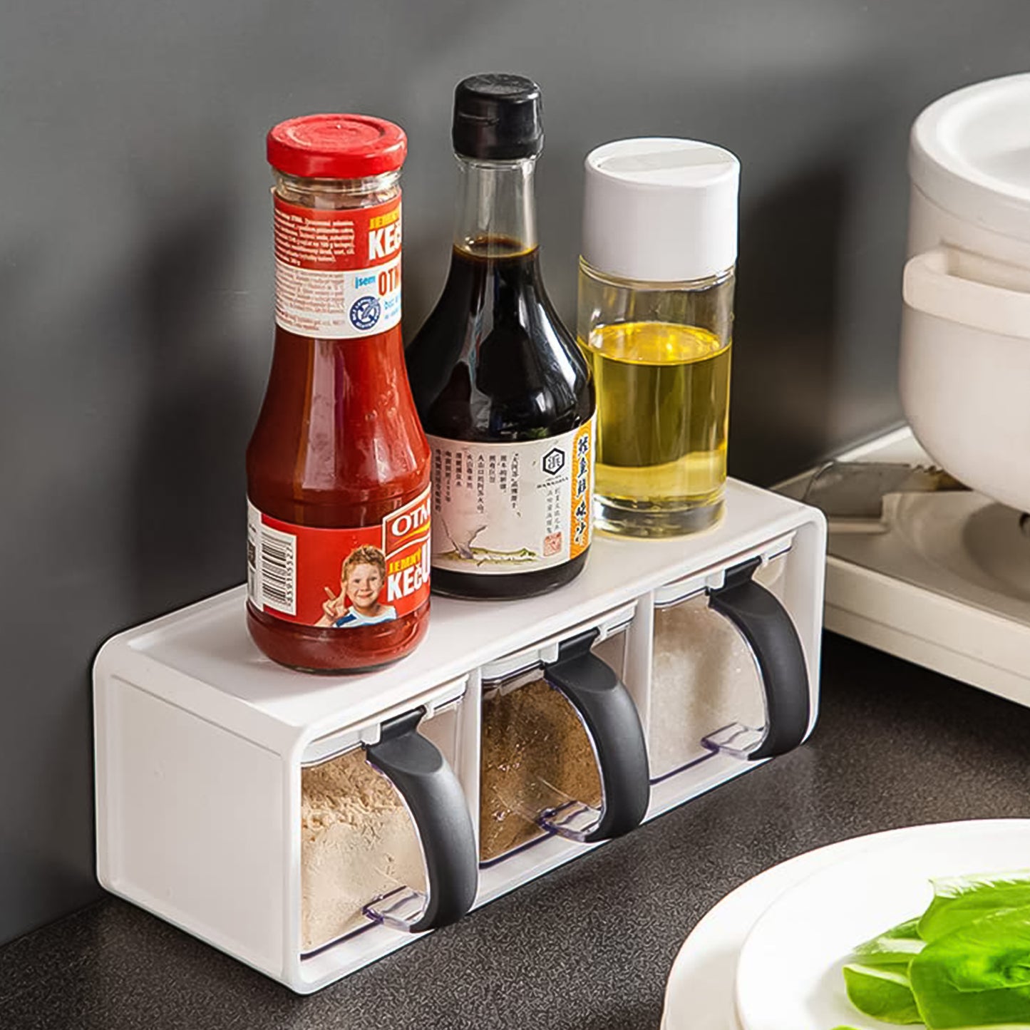 Wukusy Grinss modular spice storage box set with three clear plastic containers and black lids, neatly arranged for kitchen storage.