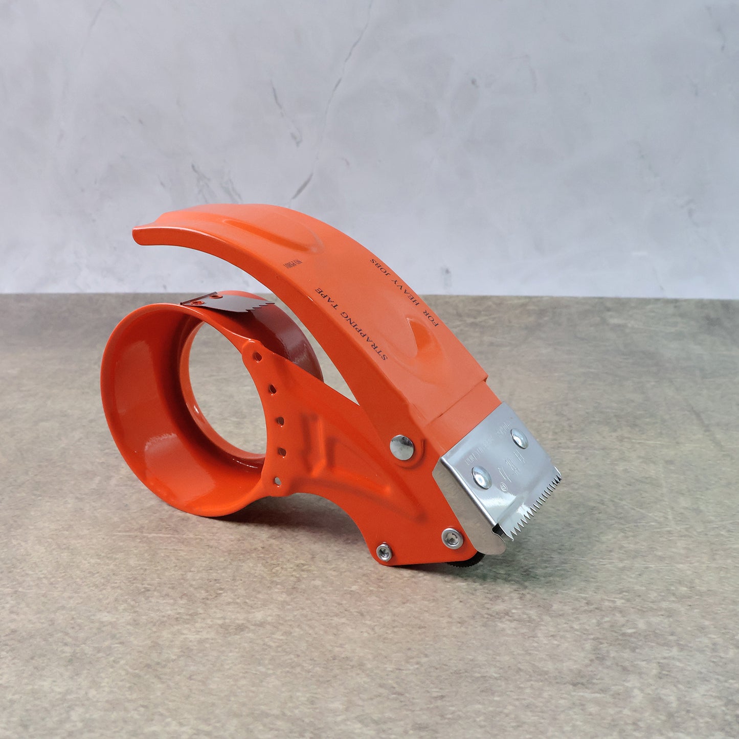 Wukusy heavy-duty packing tape dispenser holding a 50mm wide tape roll for secure sealing of packages.