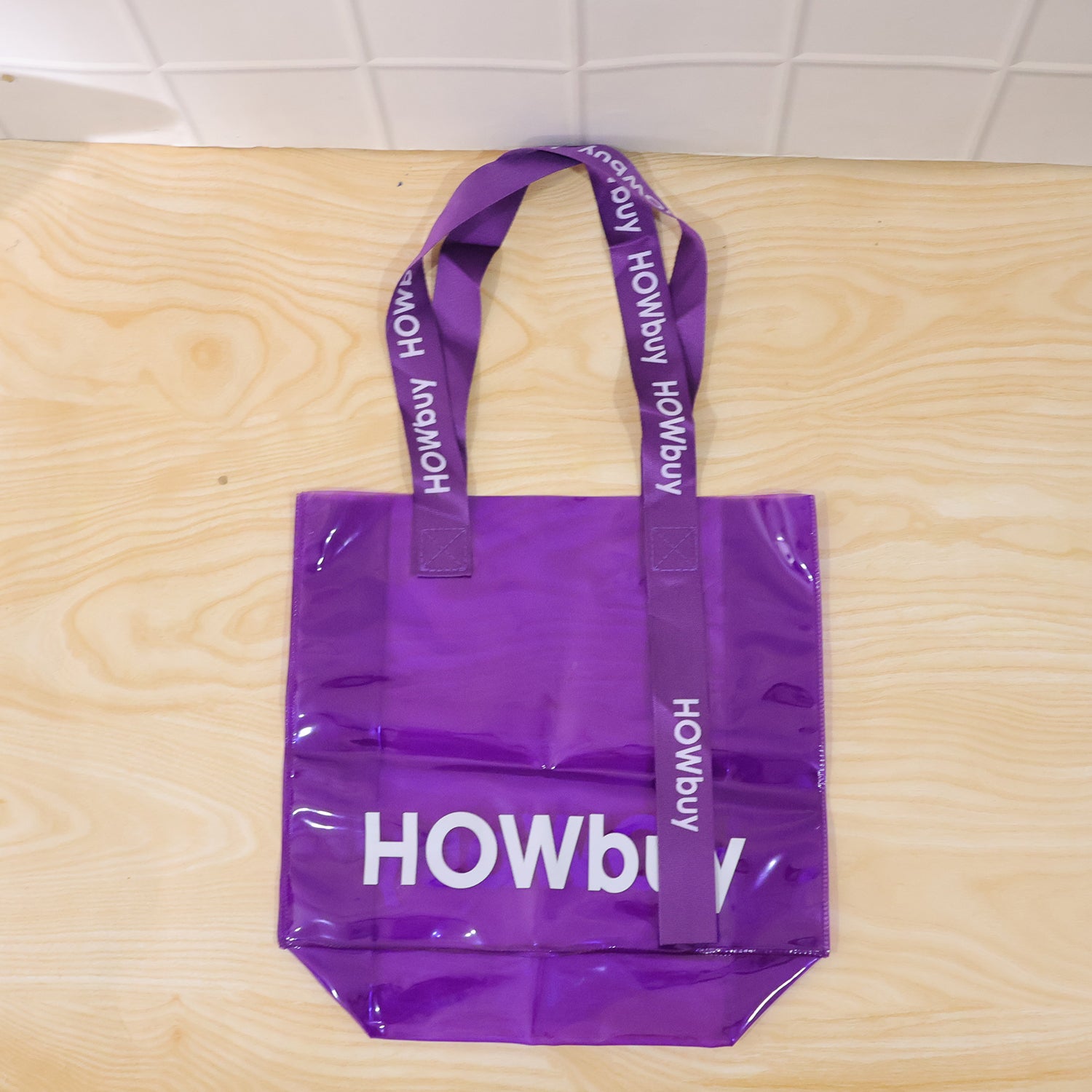 Transparent Wukusy carry bag with handle strap, 30x27 cm, showing clear plastic material and sturdy strap for easy transport.