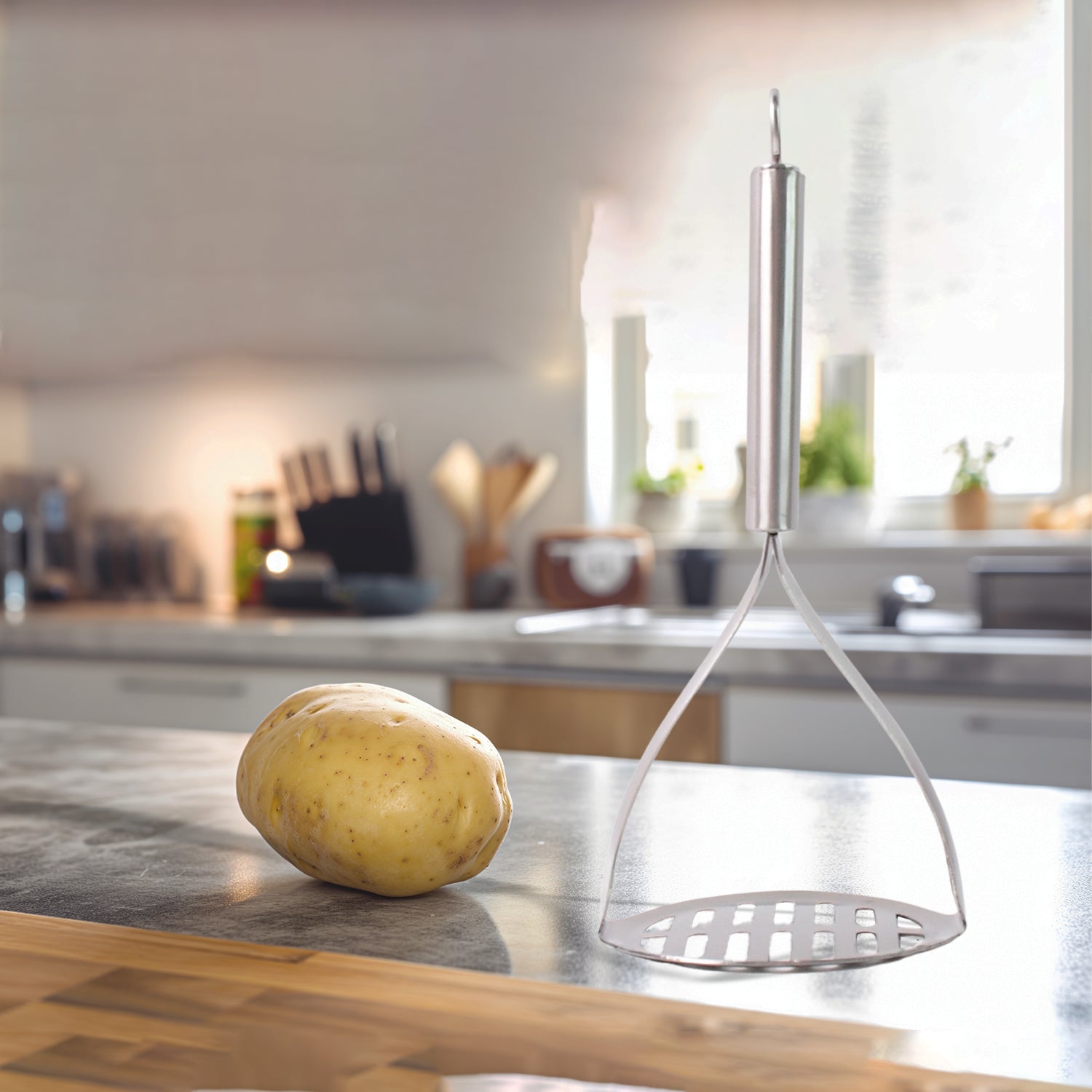 Wukusy Supermom stainless steel potato masher with stylish handle for kitchen use, featuring a durable design and ergonomic grip.
