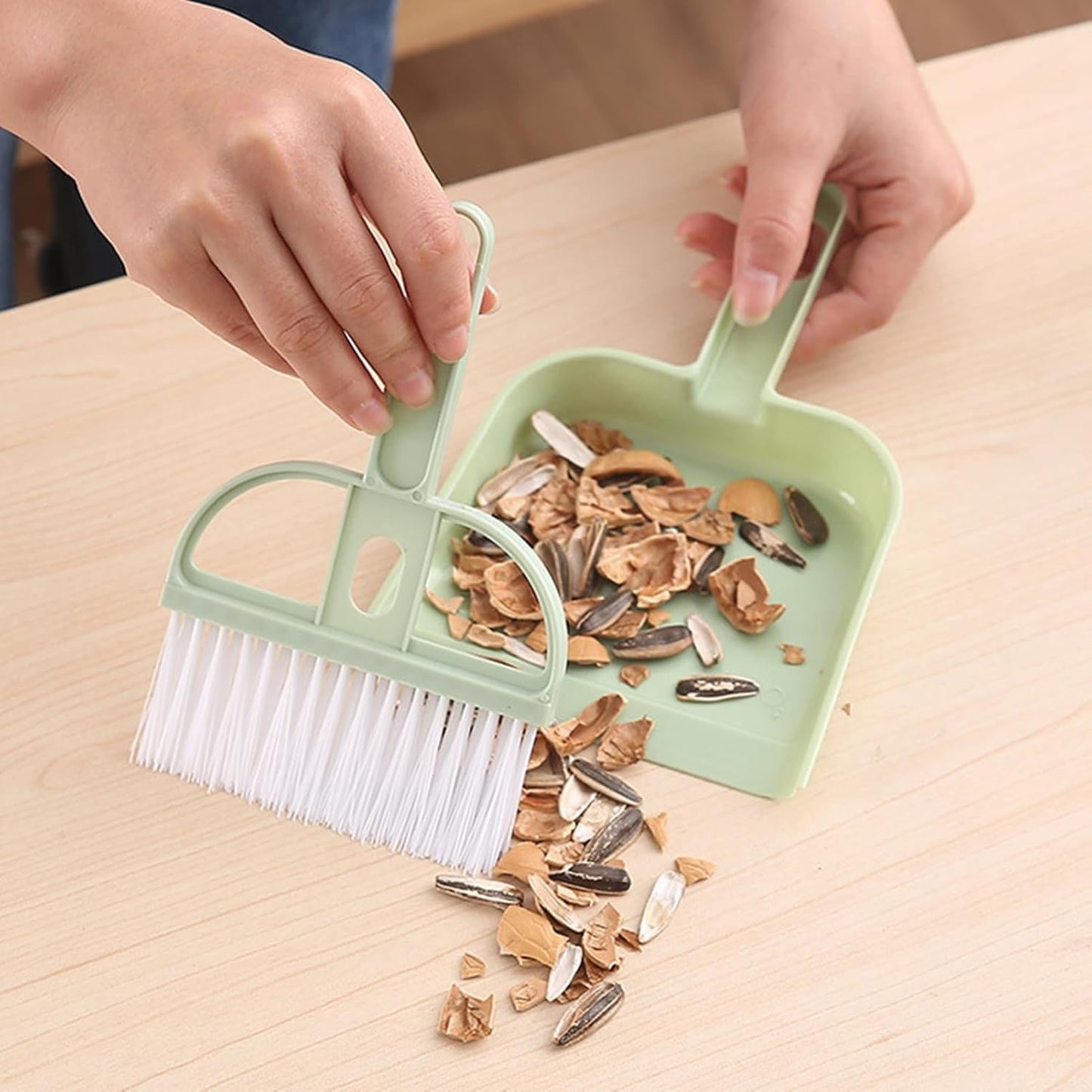 Wukusy 2-in-1 handheld cleaning dustpan with ergonomic handle and compact design for easy sweeping and debris collection.